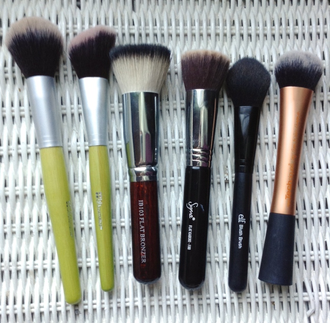 (L to R) BH Cosmetics basic powder brush and angled blush brush, Crown flat top bronzer brush, Sigma flat top kabuki, Elf tapered blush brush, Simple Techniques buffing brush